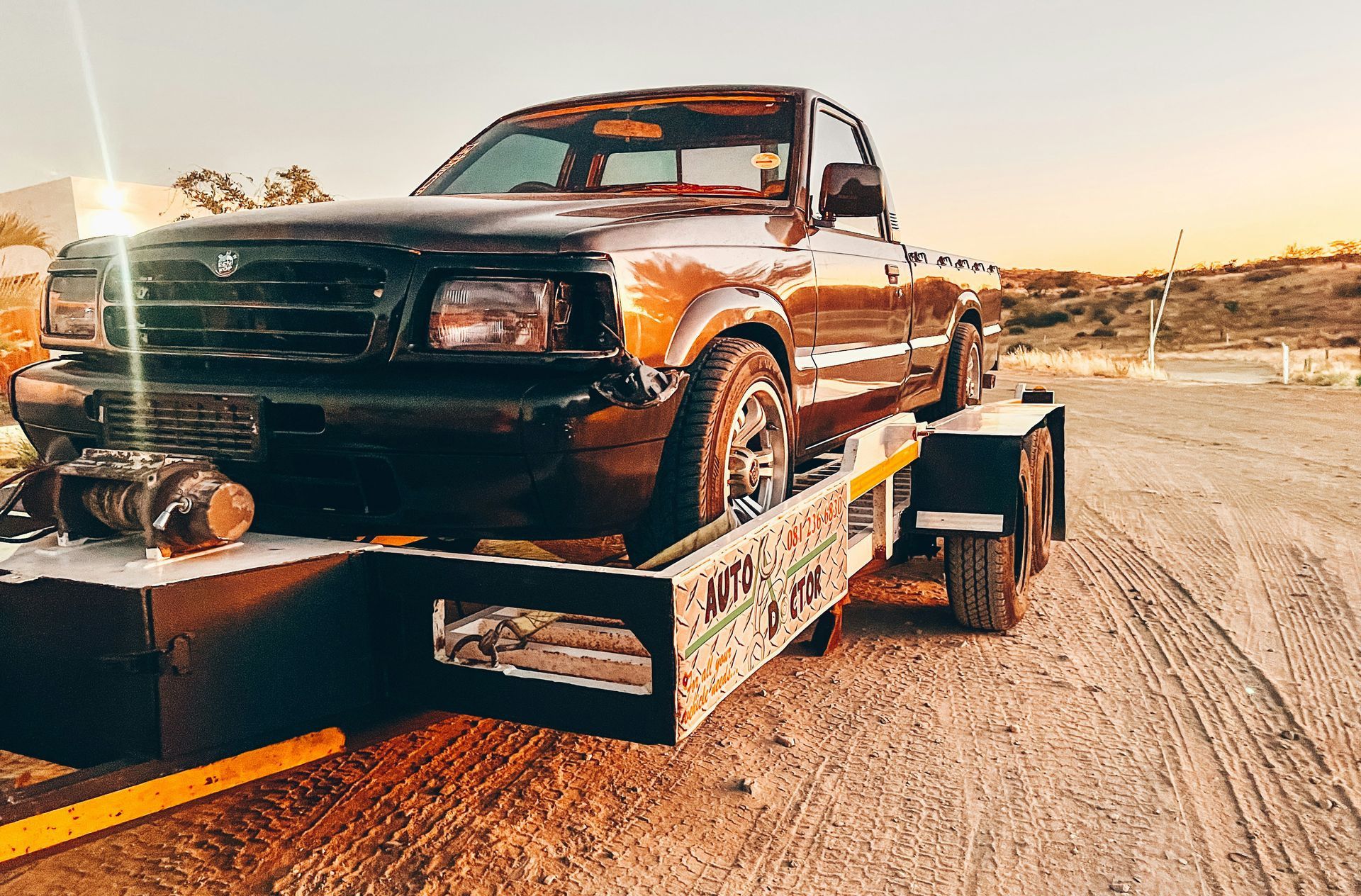 a truck is being towed on a flatbed trailer